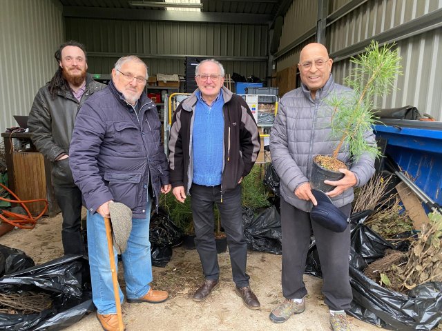 Photo of four men standing in the barn at Brocks Hill with the free trees. (L-R), OWBC Arboricultural Officer Mike Bennetto, Cllr Jeffrey Kaufman, resident Mick Dobson and Cllr Latif Darr.