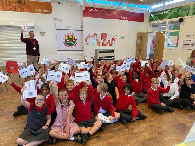 Children at Little Hill holding their poll cards ready to vote