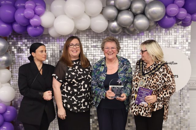 Marilyn Bowles collects her award from Mayor Clare Kozlowski (right) and Emma O’Sullivan and Katie Wade (left) from award sponsors Amberwood Care Home